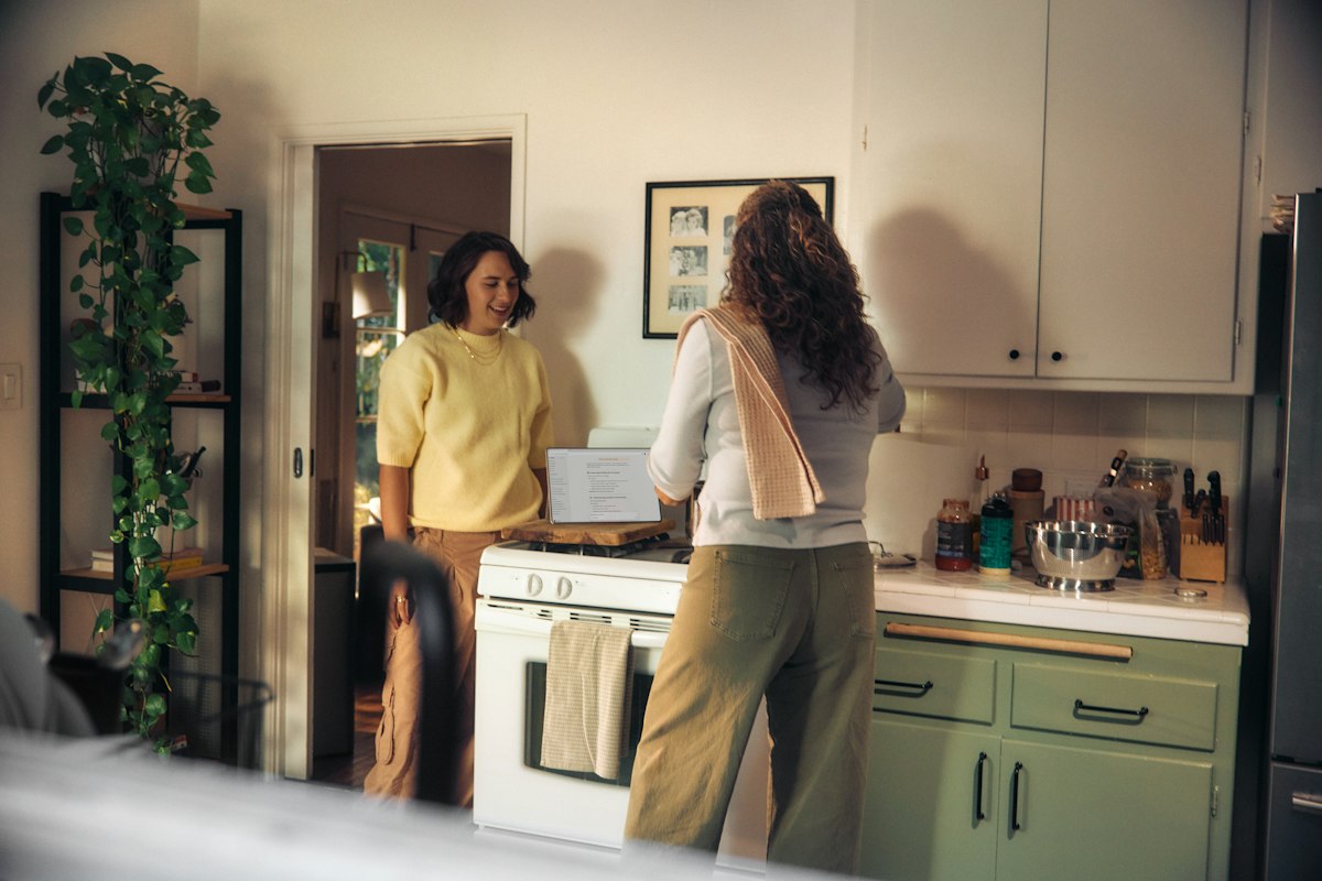 Two women talking together in a kitchen